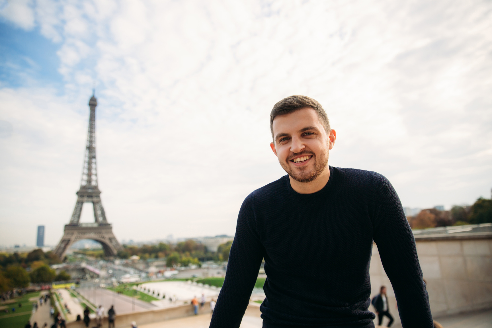 Smiling Man with the Eiffel Tower on the Background 
